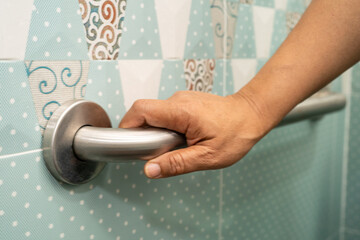 Asian elderly woman use toilet bathroom handle security, healthy strong medical.