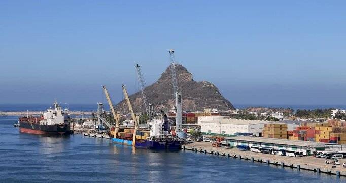 Mazatlan Mexico port cargo container fuel ships. Commercial seaport cargo, containers, automobiles, fishing and cruise ships. International industrial trade of products supplies. Port, harbor marina. 