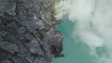 aerial view of the interior of a volcano crater, with a lake of sulphur. Java, Indonesia - 19th March 2025