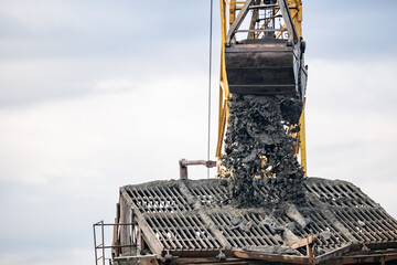 Excavator loading ore at sand quarry for mining operations