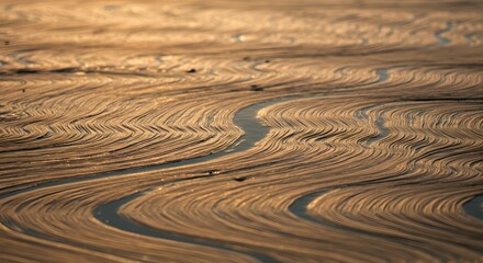 Naklejka premium Golden Hour Water Reflections Abstract Nature Photography of Wave Patterns on Sandy Shore