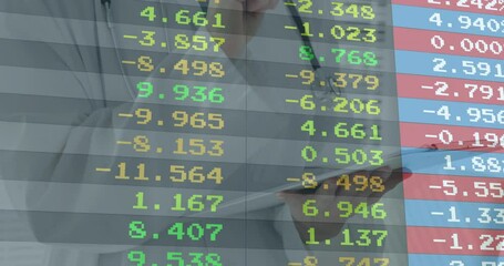 Financial analyst monitoring stock data appearing on transparent board and recording market shifts - Powered by Adobe