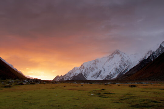 breathtaking view of nanga parbat peak at sunset with sky painted in warm hues of orange and purple