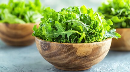 Fototapeta premium Colorful mixed greens, fresh arugula, kale, and romaine, arranged in rustic wooden bowls