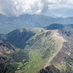 aerial landscape with Alpine shelters in Valbiondino valley, Introbio, Italy