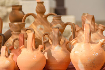 close up view of terracotta vessels at a market stall traditional ceramic water jugs and pots