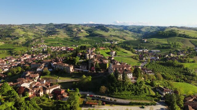 Drone footage showcasing dense historic architecture, terracotta rooftops, and narrow streets of Neive, charming medieval village in Langhe, Piedmont, Italy