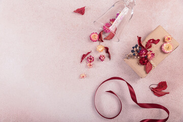 Process of wrapping and decorating presents with dried flowers. Gift boxes in craft paper and...