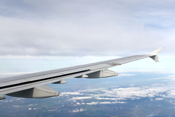 View of an airplane wing against a cloudy sky