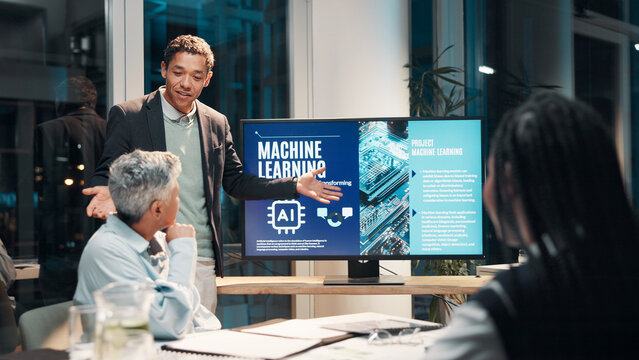 Businessman, screen and presentation in meeting for ai, machine learning or training in workshop office. Monitor, talk and team speaker with future technology for project development or idea at night