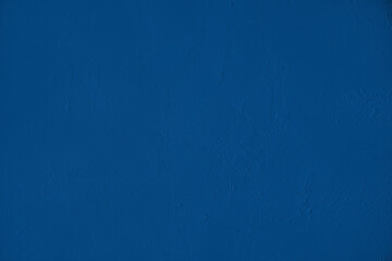 Obraz premium Elegant navy blue colored dark Concrete textured cool grunge abstract background with roughness and irregularities. 2020 color trend concept.