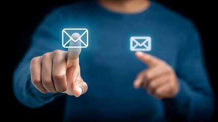 Businessperson pointing at floating email icons on dark background