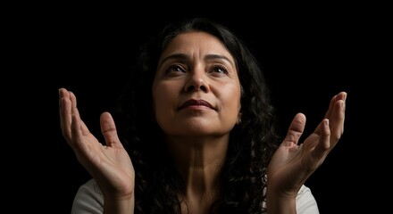 Woman Looking Up with Open Hands in Hopeful Gesture on Black Background
