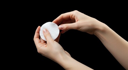 Holding White Cotton Pad for Facial Cleansing Routine in Hand