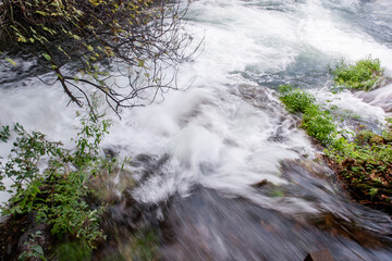 Water cascading down small waterfalls in Krka national park creates a stunning natural scene,...
