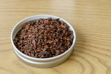 Pile of instant granulated cocoa nibs on a wooden table