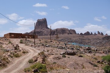 Amazing mountain landscapes of Jebel Saghro with volcanic rocks eroded by wind and time and settlement with buildings. Atlas, Anti Atlas, Morocco  © Iwona