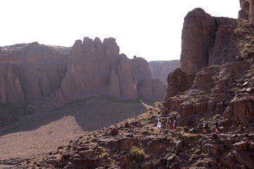 Amazing mountain landscapes of Jebel Saghro with volcanic rocks eroded by wind and time and group of trekking tourists. Atlas, Anti Atlas, Morocco © Iwona