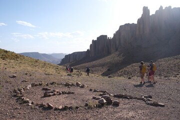 Amazing mountain landscapes of Jebel Saghro with volcanic rocks eroded by wind and time and group of trekking tourists. Atlas, Anti Atlas, Morocco © Iwona