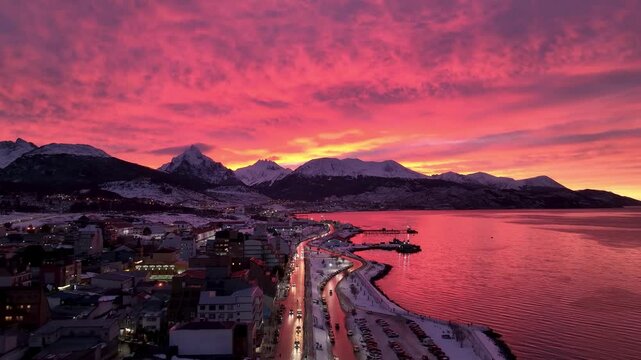 Colorful Sunset In Ushuaia Fin Del Mundo Argentina. Aerial View Of A Bustling Downtown Cityscape With Modern Buildings. Sunset Snowing Illumination Glacial Landscape Snow Capped.