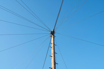 A telegraph pole carrying telephone cables to suburban houses in a town in the UK. 