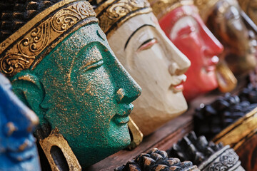 Colorful carvings of traditional statues displayed in a market in Bali, Indonesia capturing local artistry and culture