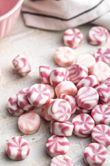 Colorful striped candies on kitchen table.
