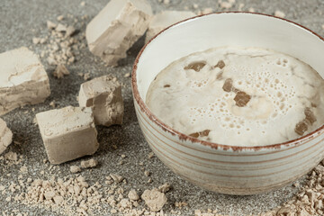 Activation of wet fresh yeast in warm water with sugar.
