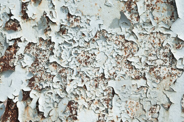 old peeling paint on metal wall close up
