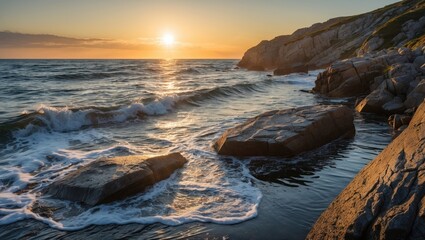 Obraz premium Sunset over the water with rocks on the shoreline during evening. Coastal scene with waves and rocky coast at dusk.