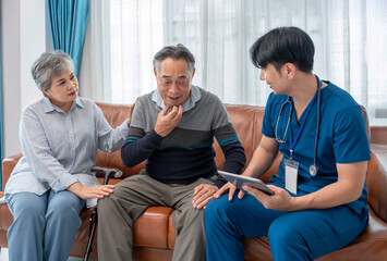 scene of senior patient talking to a visiting nurse who using tablet computer giving advice elderly...