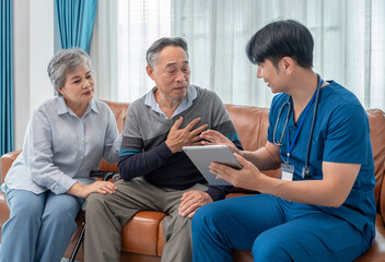scene of senior patient talking to a visiting nurse who using tablet computer giving advice elderly...