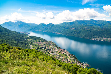 Panorama of Lake Como photographed at Alpe Mezzedo in Esino Lario, showing Bellagio, Balbianello, the Lecco and Como shores of the lake and the mountains above.
