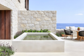 Modern outdoor space featuring serene water feature by the ocean during sunny day