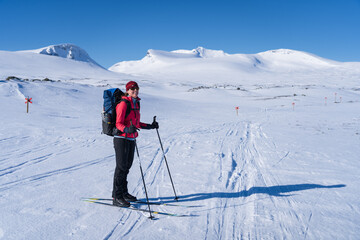 Woman enjoying a beautiful day cross-country skiing the Sylarna mountainrange. Sweden.