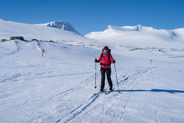 Woman enjoying a beautiful day cross-country skiing the Sylarna mountainrange. Sweden.
