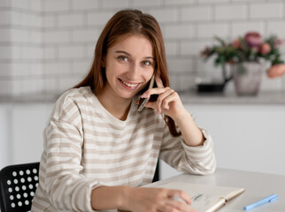 Girl Smiling While Talking On The Phone At Home