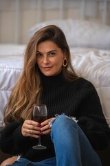 Fototapeta na wymiar Young woman with wine indoors