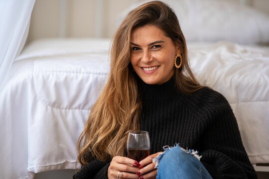 Woman in Cozy Room with Wine