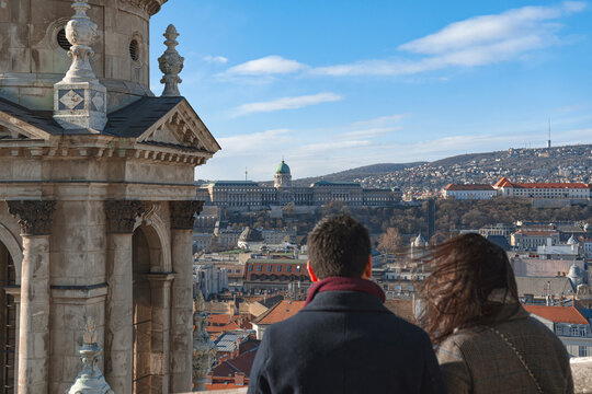 Couple admiring Budapest cityscape from st. Stephen's basilica viewpoint. Hungary - Powered by Adobe