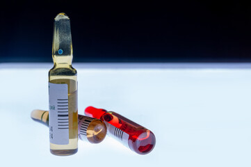Medical ampoules for injection isolated on a white background. Transparent glass vials with clear liquid used for treatment and vaccination. Sterile pharmaceutical containers in a clinical setting.