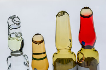 Medical ampoules for injection isolated on a white background. Transparent glass vials with clear liquid used for treatment and vaccination. Sterile pharmaceutical containers in a clinical setting.