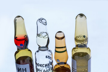 Medical ampoules for injection isolated on a white background. Transparent glass vials with clear liquid used for treatment and vaccination. Sterile pharmaceutical containers in a clinical setting.