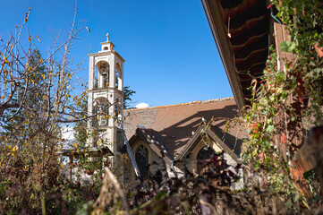 White bell tower reaching for the sky in Platanistasa village, Cyprus