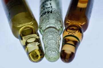 Medical ampoules for injection isolated on a white background. Transparent glass vials with clear liquid used for treatment and vaccination. Sterile pharmaceutical containers in a clinical setting.