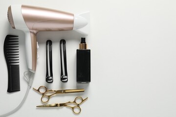 Different hairstyling tools on white background, flat lay. Space for text