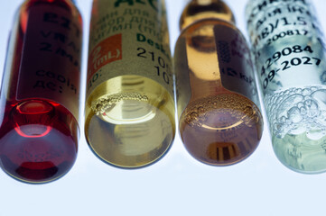 Medical ampoules for injection isolated on a white background. Transparent glass vials with clear liquid used for treatment and vaccination. Sterile pharmaceutical containers in a clinical setting.