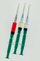 Set of medical syringes with antibiotics and vitamins on a white background. Injection needles and a vial for vaccination. Medical instruments for administering drugs.