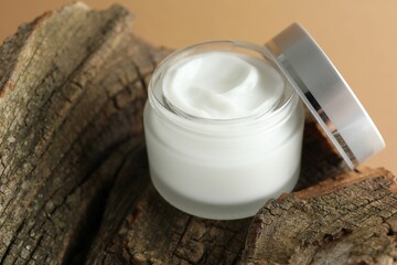 Jar of body cream on beige background, closeup
