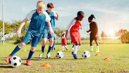 Playing, soccer player and children with ball, kick and athlete with energy for practice in...